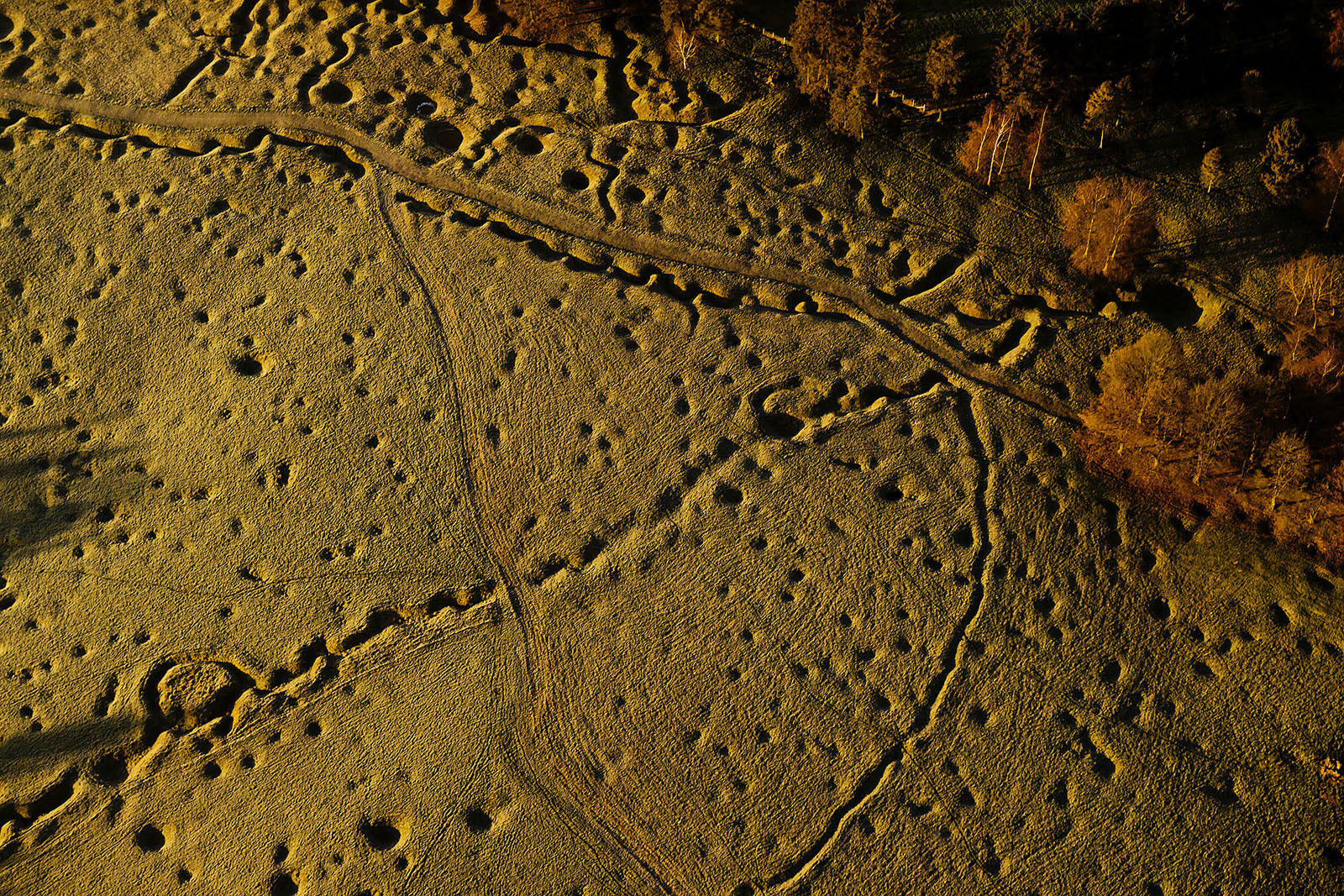 Modern photograph high over a field. Trenches are carved into the field.